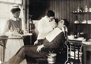 DENTISTRY, 1917. Dentist working on a patient in a hospital, Cambridge, Massachusetts DENTISTRY, 1917. Dentist working on a patient in a hospital, Cambridge, Massachusetts