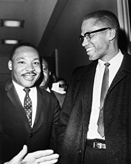 Dr. Martin Luther King Jr. (left), American cleric and civil rights leader, photographed with American religious and political leader Malcolm X at the Capitol in Washington, D.C., 26 March 1964