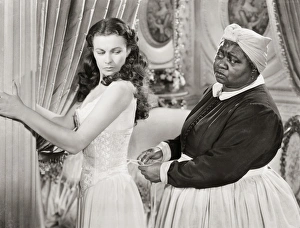 GONE WITH THE WIND, 1939. Hattie McDaniel assists Vivien Leigh while offering some unwelcomed advice GONE WITH THE WIND, 1939. Hattie McDaniel assists Vivien Leigh while offering some unwelcomed advice