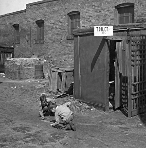 MARBLE GAME, 1936. Two boys playing marbles, next to an outhouse in St. Louis, Missouri MARBLE GAME, 1936. Two boys playing marbles, next to an outhouse in St. Louis, Missouri