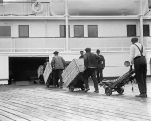 Vintage Shipping Images Prints: LOADING FREIGHT, c1924. Dockworkers loading cargo onto a steamship. Photograph, c1924