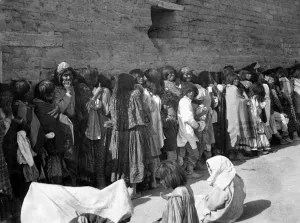 Southwest Native Americans Prints: APACHE RESERVATION, c1899. Line of Apache men, women and children wait for rations