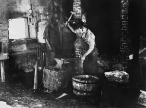 19th Century Occupations Prints: BLACKSMITH AT WORK. A blacksmith and assistant at work. Undated photograph