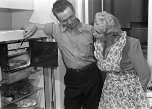 REPAIRMAN, 1942. A repairman inspecting a refrigerator. Photograph by Ann Rosener, 1942 REPAIRMAN, 1942. A repairman inspecting a refrigerator. Photograph by Ann Rosener, 1942