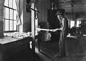TEXTILE MILL WORKER, 1908. Old man inspecting yarn. Rhodes Manufacturing Company TEXTILE MILL WORKER, 1908. Old man inspecting yarn. Rhodes Manufacturing Company