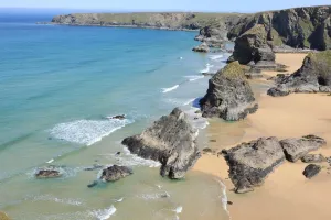Prints of The Bedruthan Steps on the North Coast of Cornwall near St Eval; on a spring day with the Thrift or Sea Pink out in flower Images Dated 2012 May: Print of The Bedruthan Steps at low tide, Thrift in bloom