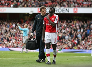 Arsenal physio Colin Lewin with injured Kolo Toure Arsenal physio Colin Lewin with injured Kolo Toure