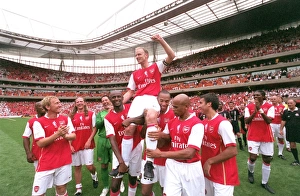 Dennis Bergkamp is chaired by Patrick Vieira and Thierry Henry Dennis Bergkamp is chaired by Patrick Vieira and Thierry Henry
