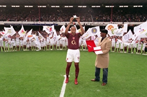 Thierry Henry is presented with a golden canon by Ian Wright for becoming Arsenals all Thierry Henry is presented with a golden canon by Ian Wright for becoming Arsenals all