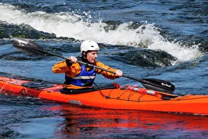 A sea kayaker at the Falls of Lora at Connel in Scotland A sea kayaker at the Falls of Lora at Connel in Scotland