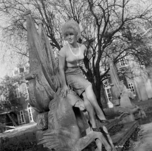 Prints of Gwendolyn Watts (Rita) poses on an ornate sculpture for a portrait to promote the release of Billy Liar in 1963 Rita Prints: A Portrait of Gwendolyn Watts Print
