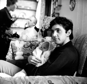 David Essex Prints: StudioCANAL Print of David Essex as Jim Maclaine holding a baby