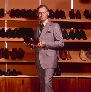 Male shoe salesman in grey suit