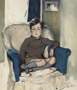 A young boy sits in a large armchair