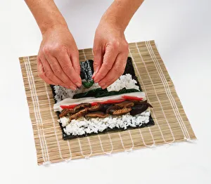 1 - Place a lightly toasted nori sheet on a bamboo mat 1 - Place a lightly toasted nori sheet on a bamboo mat