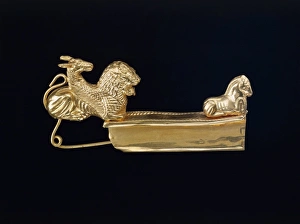 Arched gold fibula (metal brooch) with chimeras and horse Arched gold fibula (metal brooch) with chimeras and horse