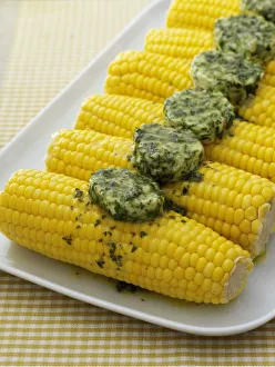 Corn on the cob topped with herb butter Corn on the cob topped with herb butter