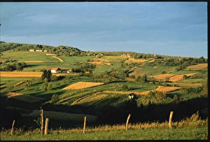 Croatia, Northern Counties, Belec, cultivated rolling landscape and farmhouses in village among hills of Zagorje