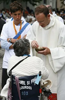 Disabled woman receiving holy communion Disabled woman receiving holy communion