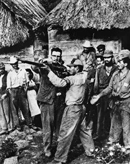 Fidel castro giving rifle instruction to new recruits to his revolutionary army in sierra Fidel castro giving rifle instruction to new recruits to his revolutionary army in sierra