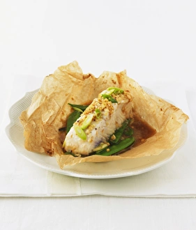 Halibut in paper with mangetouts, spring onions, nuts and sauce Halibut in paper with mangetouts, spring onions, nuts and sauce
