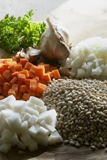 Ingredients for casserole, chopped carrots and onions, sprig of parsley, two cloves of garlic and barley seeds Ingredients for casserole, chopped carrots and onions, sprig of parsley, two cloves of garlic and barley seeds