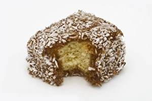 Lamington sponge cake with a bite taken from it Lamington sponge cake with a bite taken from it