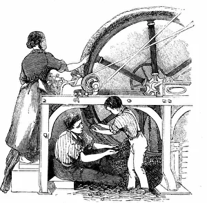 Man, woman & small boy working wheel for combing long staple wool into slivers for Man, woman & small boy working wheel for combing long staple wool into slivers for