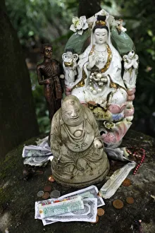 Money offering and statues in the garden of Buddhapadipa temple Money offering and statues in the garden of Buddhapadipa temple