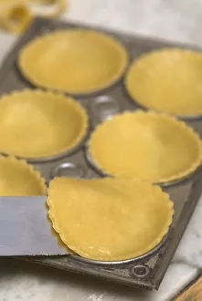 Placing pastry discs into the individual bases Placing pastry discs into the individual bases