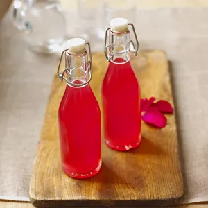 Rhubarb and rose petal syrup in two bottles Rhubarb and rose petal syrup in two bottles