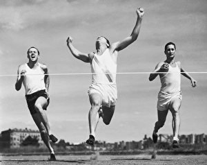 Three runners at the finish line Three runners at the finish line