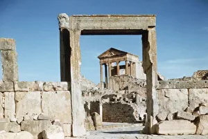 Tunisia, Dougga, Roman ruins of the Capitol viewed through Dar el Acheb portal Tunisia, Dougga, Roman ruins of the Capitol viewed through Dar el Acheb portal