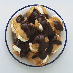 Above view of Chocolate Coated Profiteroles, filled with Whipped Cream