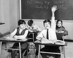Vintage image of boy raising hand in classroom Vintage image of boy raising hand in classroom