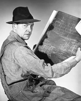Vintage man looking through classified ads in newspaper Vintage man looking through classified ads in newspaper