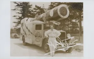 Prints of The Great Wilno. ca. 1935, USA, The Great Wilno, a human cannon ball, stands beside his specially designed truck mounted cannon Vintage Postcard Prints: The Great Wilno Print, a human cannonball beside his truck-mounted cannon