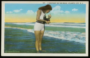 Prints of Postcard of a Woman Photographing the Ocean. ca. 1921, 147 A Snapshot on the Beach, Atlantic City, N.J. Published by Saltzburgs Merchandise Co. Atlantic City, N.J Vintage Postcard Prints: Print of a woman photographing the ocean