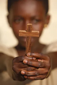 Young African christian holding a cross Young African christian holding a cross