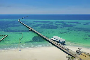Aerial view of Busselton Jetty on a sunny day with tourists in front of souvenir shop in Aerial view of Busselton Jetty on a sunny day with tourists in front of souvenir shop in