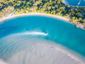 Aerial View of Noosa River with boat passing through Aerial View of Noosa River with boat passing through