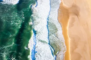 An aerial view of waves crashing on a beach , New South Wales in the morning An aerial view of waves crashing on a beach , New South Wales in the morning