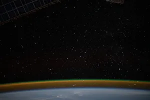 Airglow blankets the Earth's horizon beneath a starry sky Airglow blankets the Earth's horizon beneath a starry sky