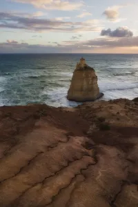 Twelve Apostles Sea Rocks Prints: A sea stack below an eroding cliff edge at sunset, Great Ocean Road, Victoria, Australia