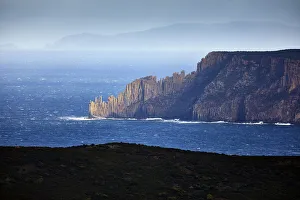 Blue seascape with sun illuminated rocky headland, Cape Raoul, Tasmania, Australia Blue seascape with sun illuminated rocky headland, Cape Raoul, Tasmania, Australia