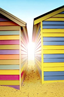 Bright sunlight between beach huts Bright sunlight between beach huts