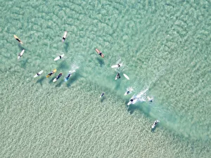 crystal clear waters with surfers seen from above crystal clear waters with surfers seen from above