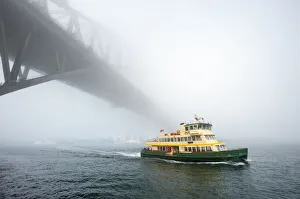 Iconic Sydney Ferry passing the Bridge on a misty day Iconic Sydney Ferry passing the Bridge on a misty day
