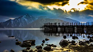 The pier at Lake Chuzenji with snow capped mountains, in a late winter evening The pier at Lake Chuzenji with snow capped mountains, in a late winter evening