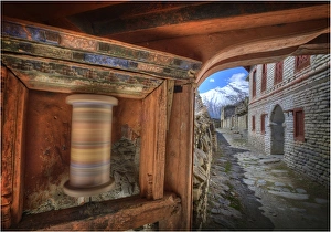 A spinning Prayer wheel used in worship, in the high mountain village of Tukuch, Mustang, Western Himalayas, Nepal A spinning Prayer wheel used in worship, in the high mountain village of Tukuch, Mustang, Western Himalayas, Nepal